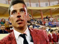 An anxious Hugo Figueira, the lead forcado of the Forcados Amadores do Redondo, is covered in blood after successfully making the 'pega' (the grab) at a bullfight in Figueira da Foz, Portugal.  Hugo was promoted to the commander of his group shortly after this bullfight because of his contnued success in grabbing the charging bull.   PETER PEREIRA